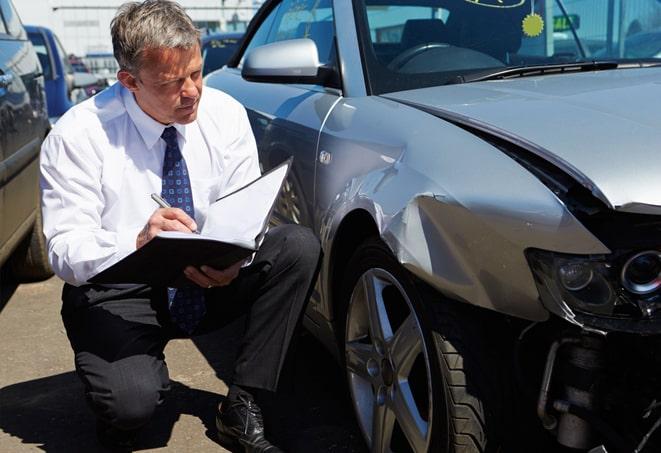 woman signing paperwork for car insurance